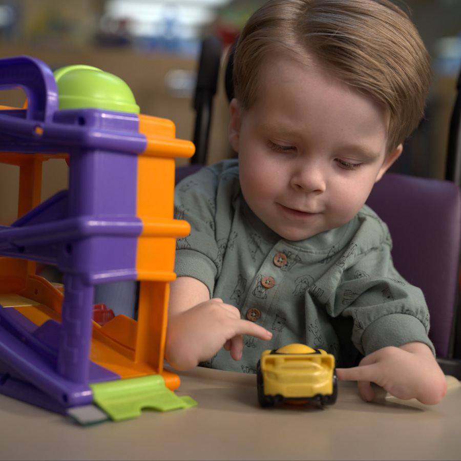 Child playing with toy cars.