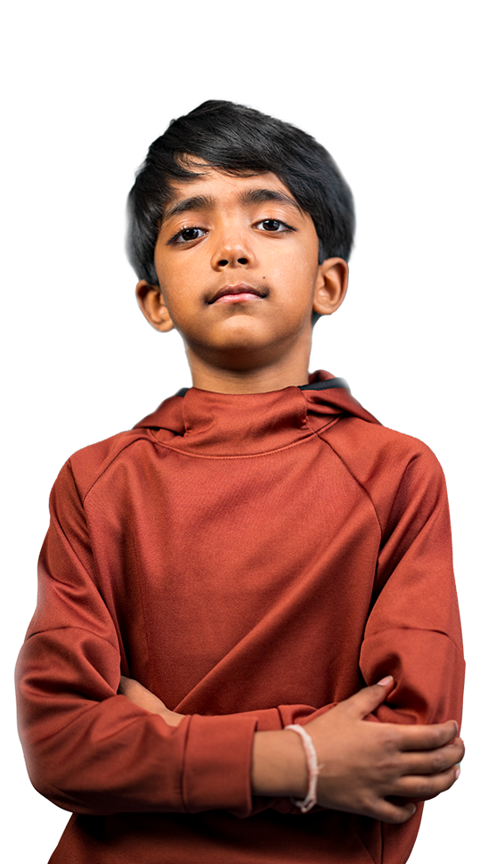 Child with his arms crossed, looking at the camera.